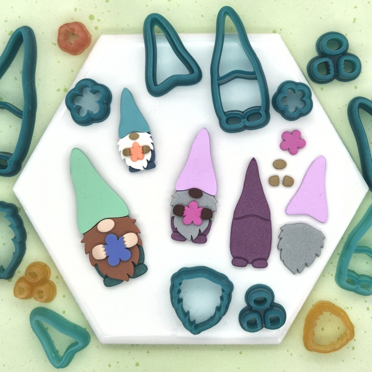 Garden Gnome polymer clay cutter set which includes five cutters: the body, hat, beard, hands or nose, and flower cutters.