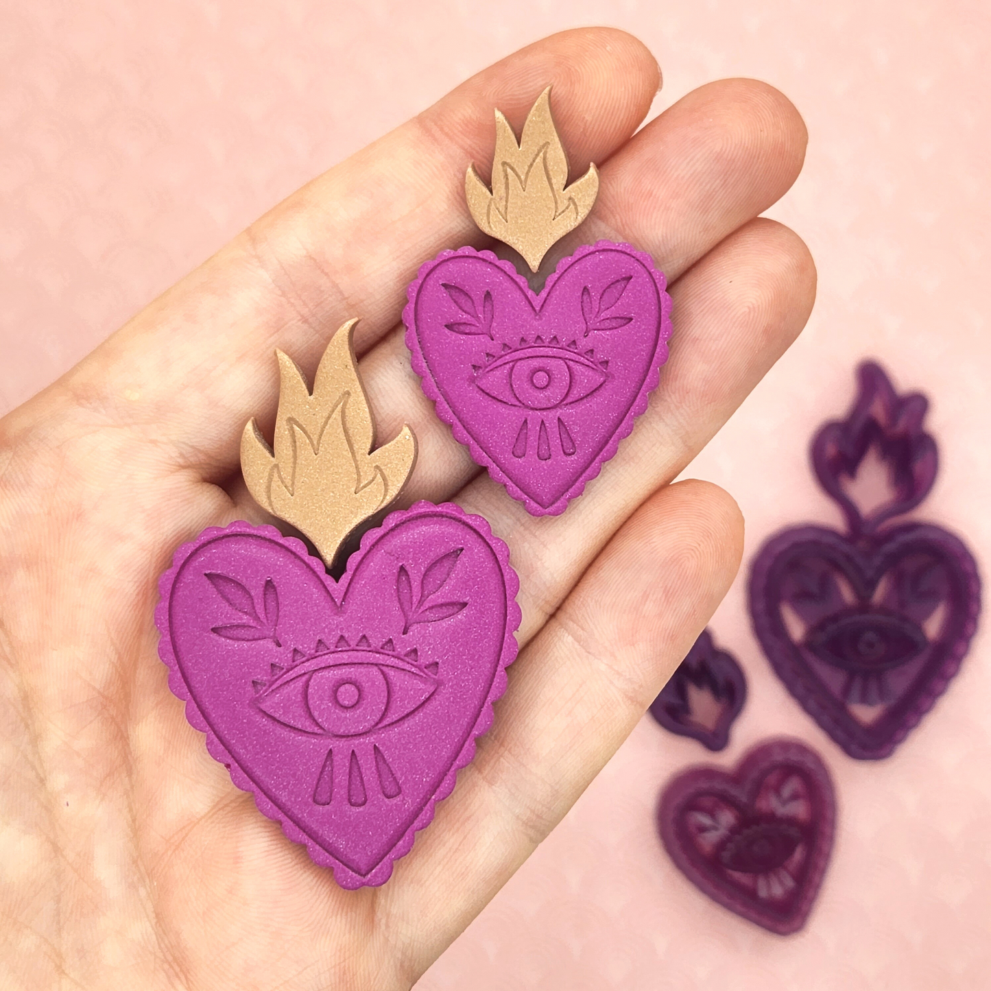 Showing the sacred heart polymer clay output in detail. Sacred Heart Design: Heart with curved outline and eye inside, and fire.