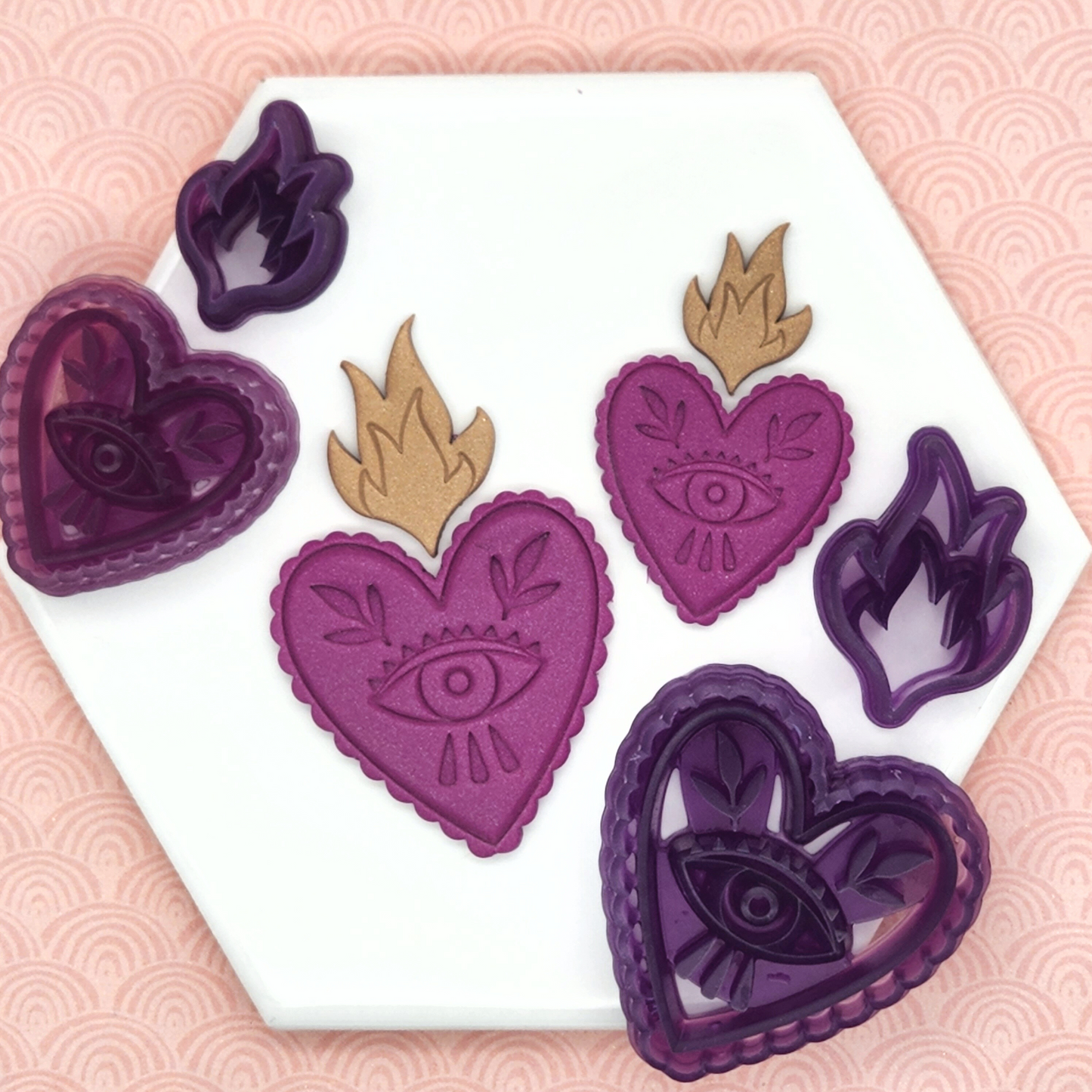 Sacred Heart Design: Heart with curved outline and eye inside, and fire. Violet sacred heart polymer clay sample output with the sacred heart clay cutter on the sides