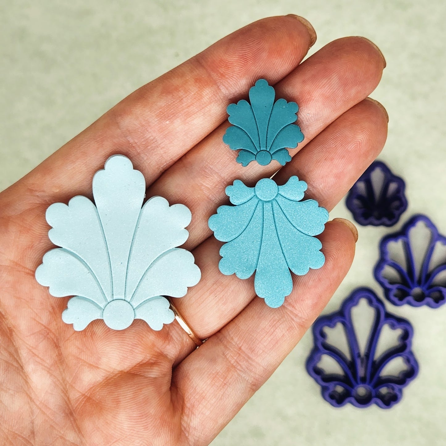 Filigree flower debossing details on polymer clay earring shapes