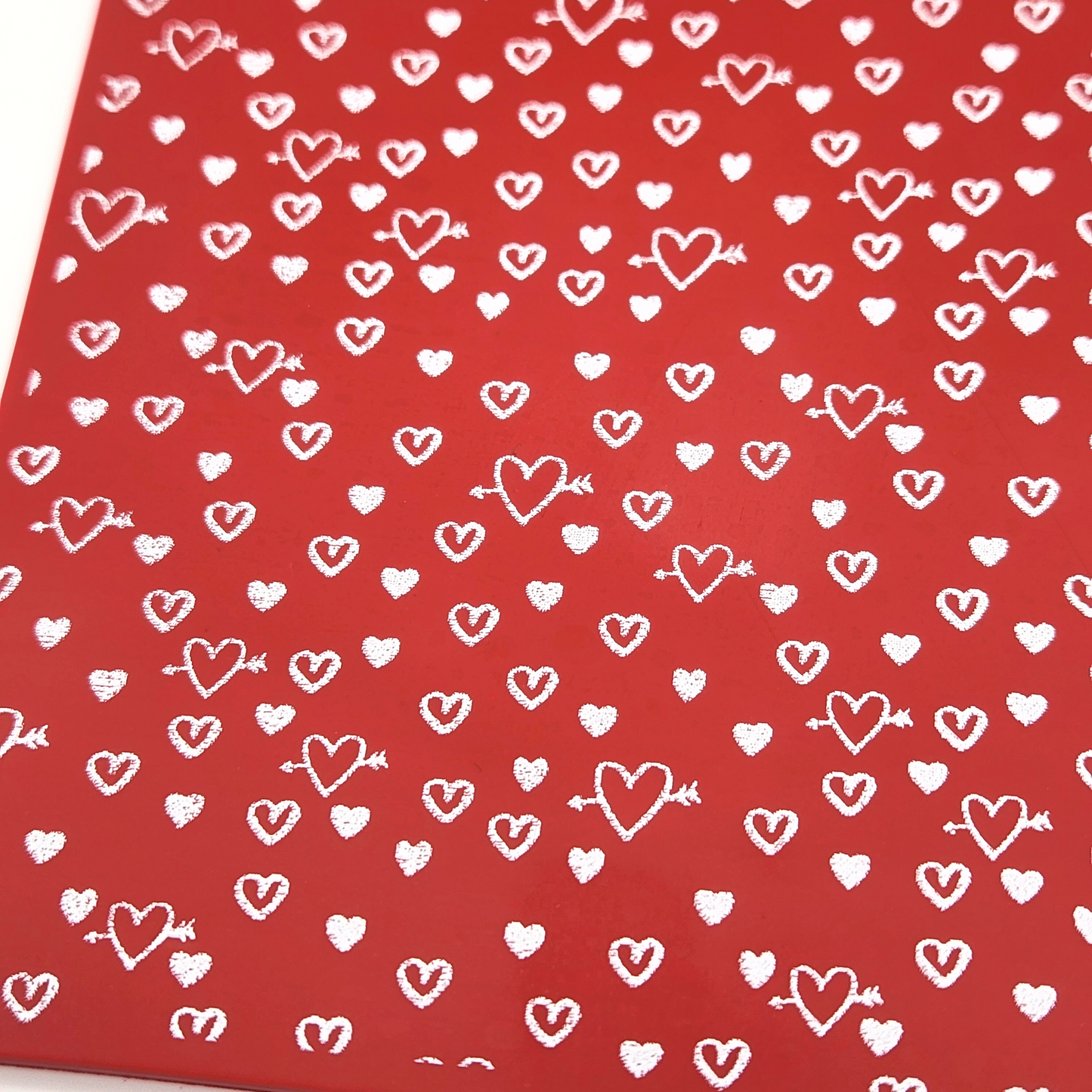 close up and detailed shot of hearts and arrows silk screen on polymer clay