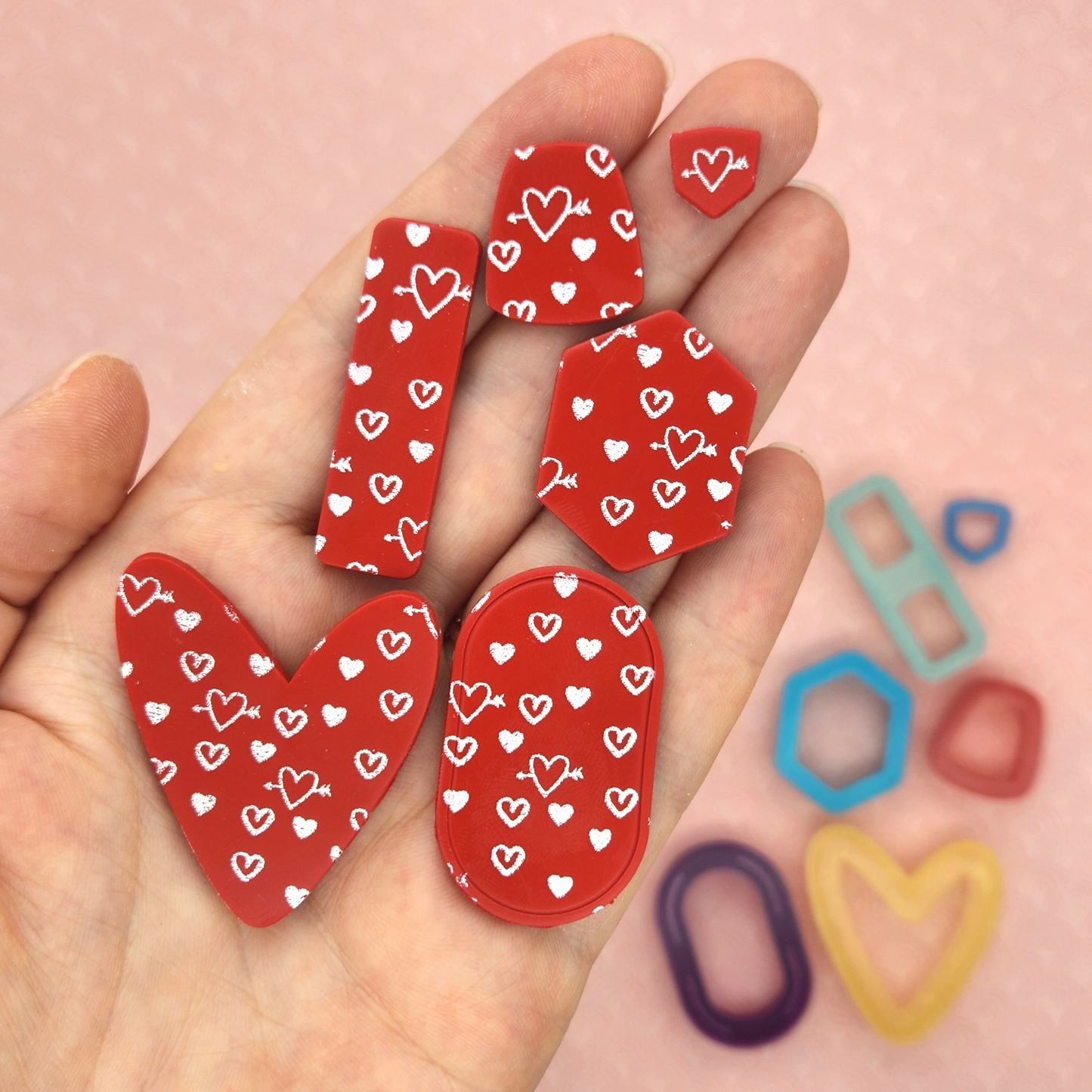 sample output of hearts and arrows silk screen on polymer clay shapes
