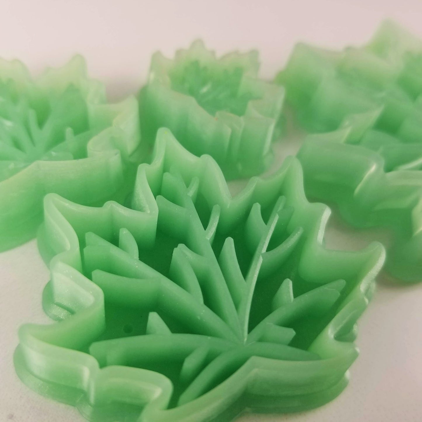 Maple leaf polymer clay cutters up close so you can see the sharp cutting edge and debossing. Beveled cutting edge.