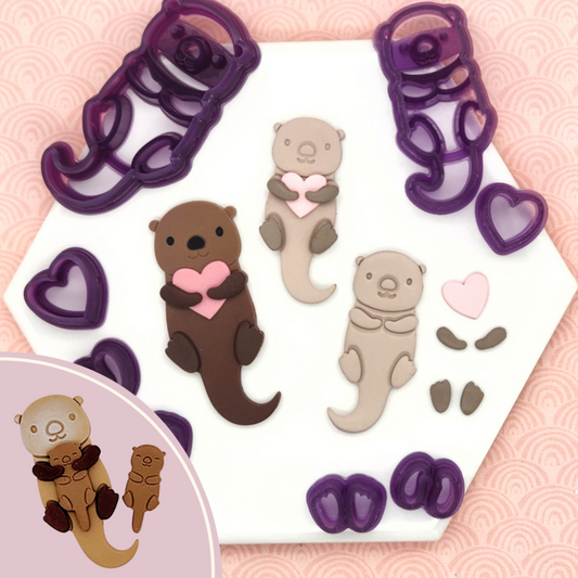 Otter Love Valentine's Day heart clay cutter. Otter Love clay cutter set includes Otter, heart, a double-paws cutter, and a double-flipper cutter. In photo, sample finish product in polymer clay and Otter Love clay cutter set