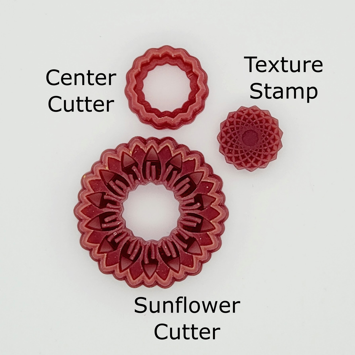 Three pieces of the Sunflower Polymer Clay cutter laid out and labeled. Cutters and texture stamp.