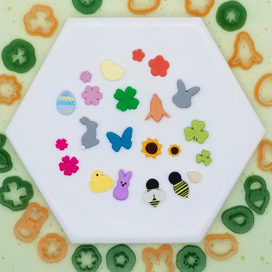 Tiny spring set includes Bumble Bee with separate teardrop shaped cutter for the wings, Bunny Head, Bunny Profile, Butterfly, Chick, Easter Egg, Four-Leaf Clover, Peeps Candy Bunny, Peeps Candy Chick, Shamrock in two sizes, Sunflower in two sizes, and oth