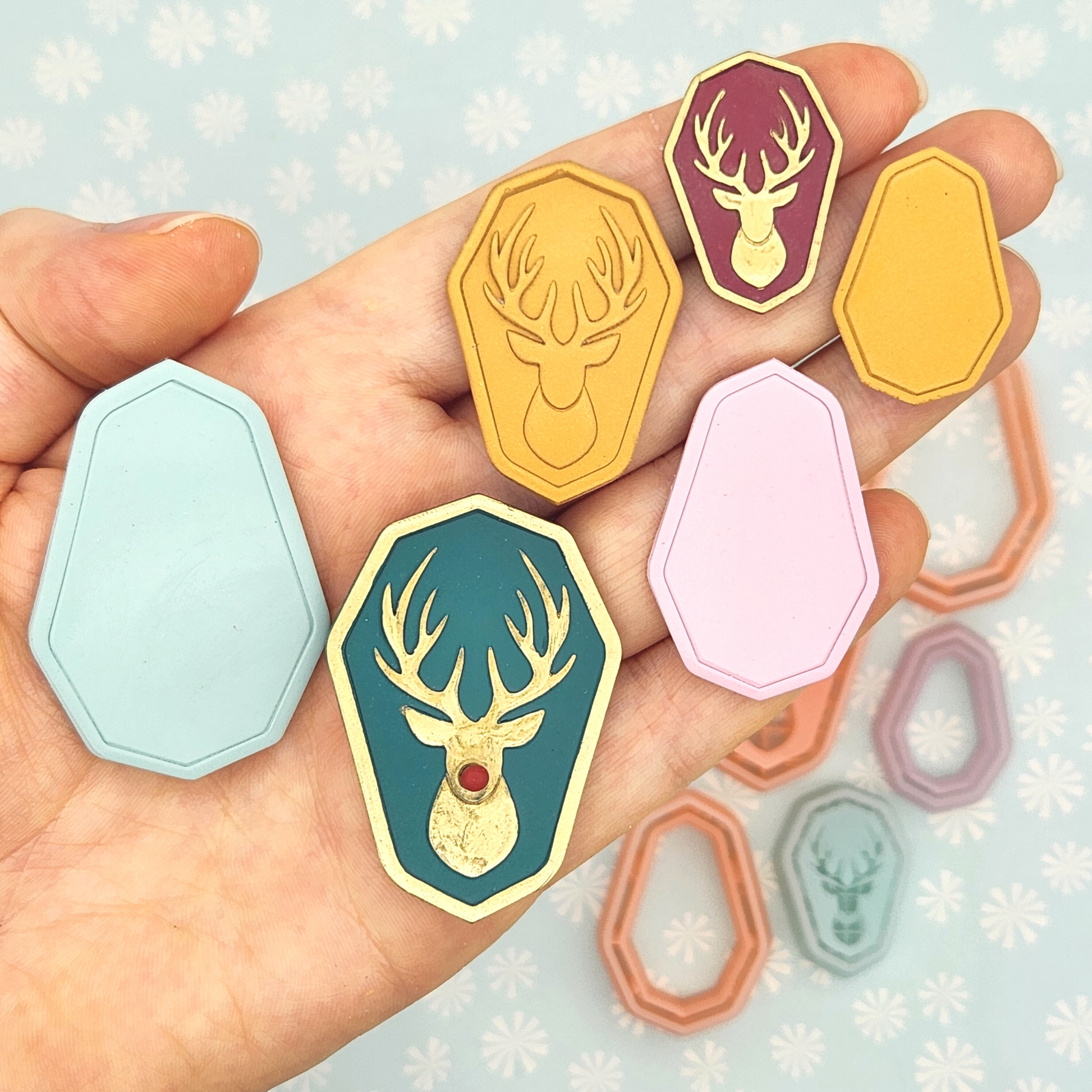 Person holding actual Reindeer Amulet on polymer clay using Reindeer Amulet polymer clay cutter