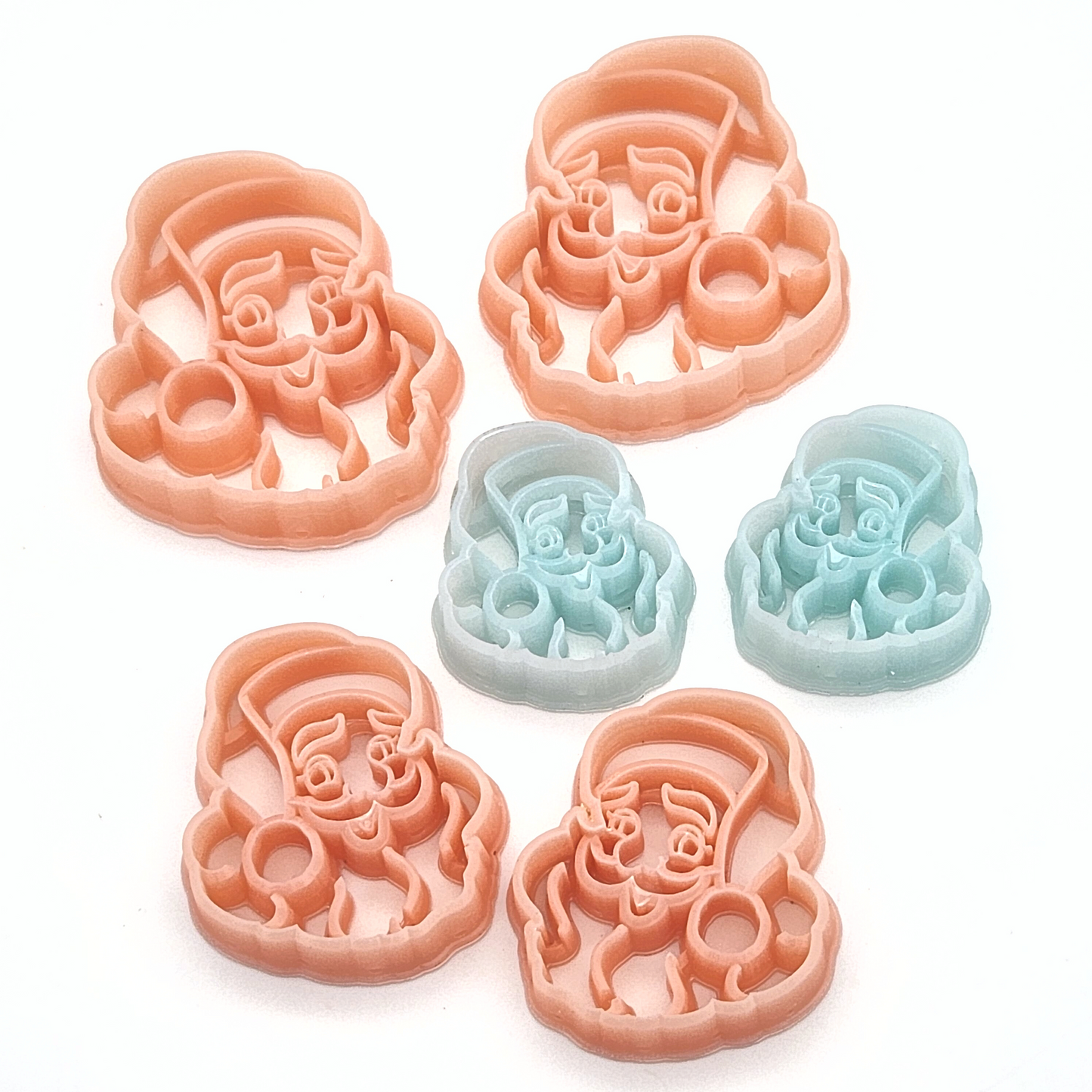 Mirrored set of Vintage Santa Claus cutters for polymer clay crafting.