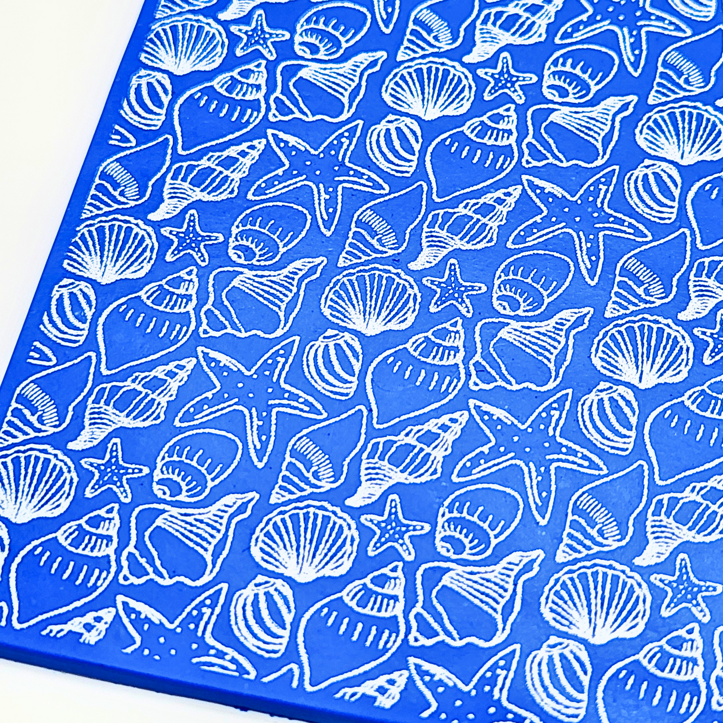 A close-up view of the silk screen pattern, highlighting the intricate sea-themed patterns including shells and starfish.