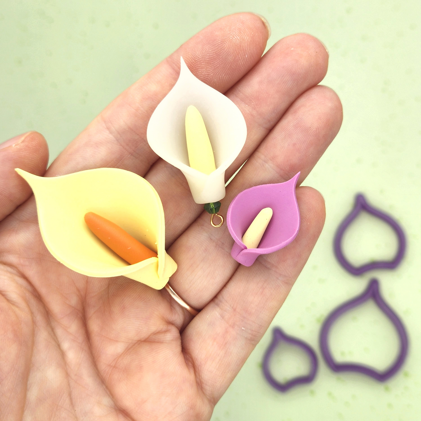 3D Calla Lily design polymer clay sample finish product. Three sizes Calla Lily petals polymer clay cutter on background