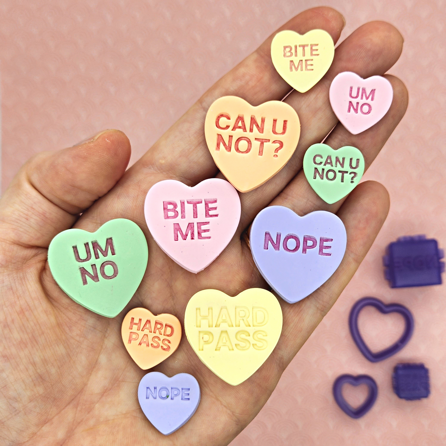 candy conversation hearts on polymer clay with words "CAN U NOT?", "BITE ME", "UM NO", "NOPE", and "HARD PASS". Sample finish product