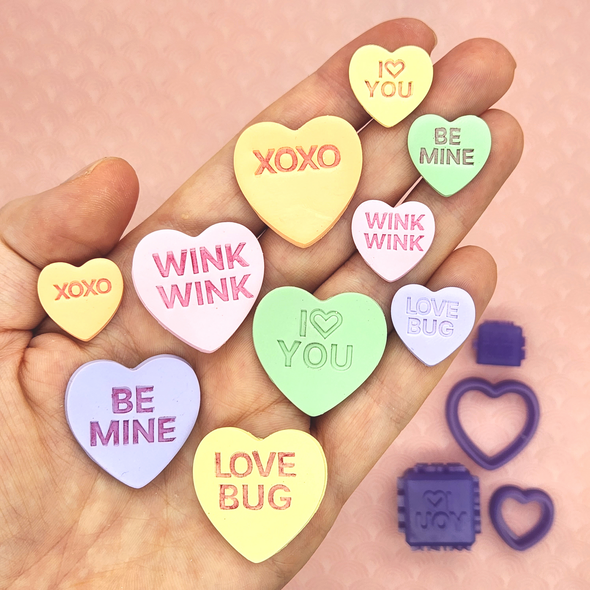 candy conversation hearts on polymer clay with words "I 🤍 YOU", "BE MINE", "WINK WINK", "XOXO", and "LOVE BUG". Sample finish product