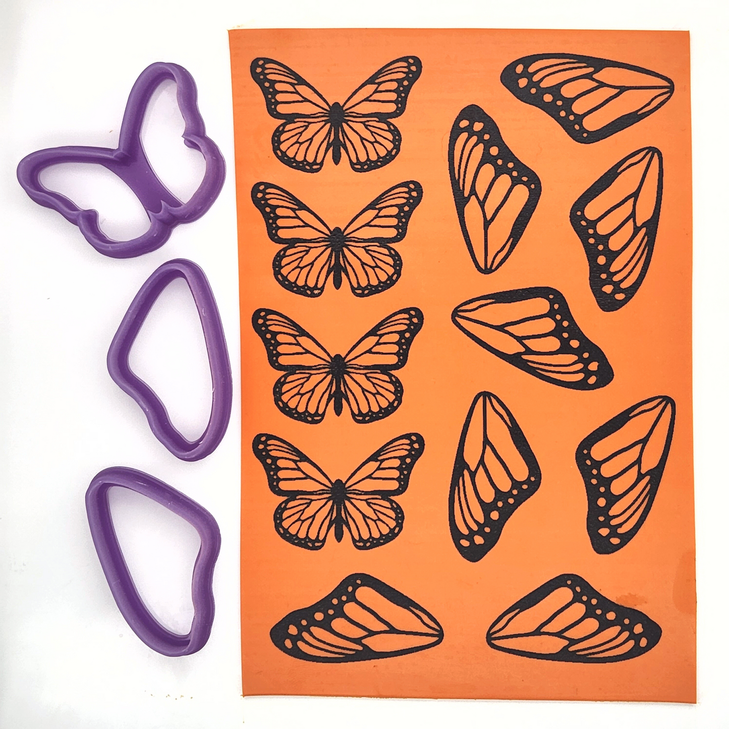 Monarch butterfly design silk screen clay painted on polymer clay slab, alongside monarch butterfly and butterfly wings matching cutters