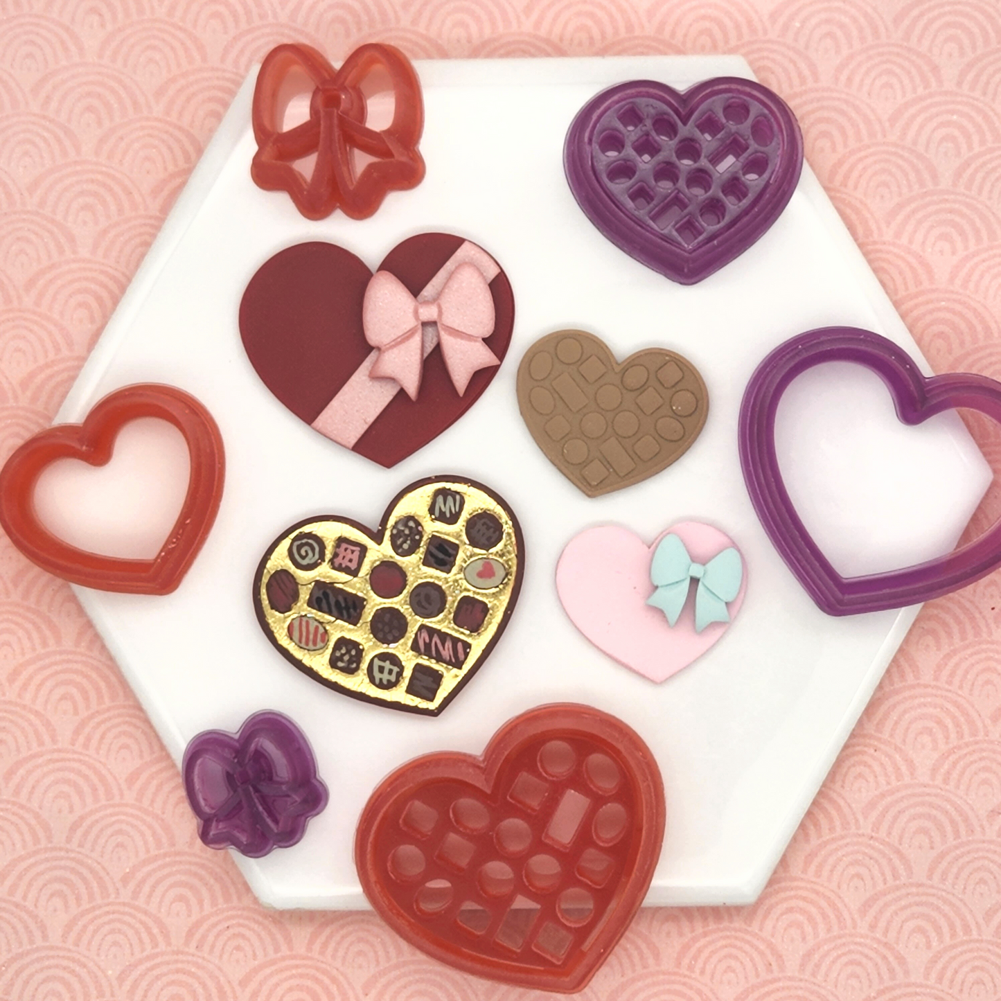 Polymer clay box of chocolates and box of chocolates set includes three cutters, a heart-shaped box of chocolates, a lid for the box, and a bow for the lid