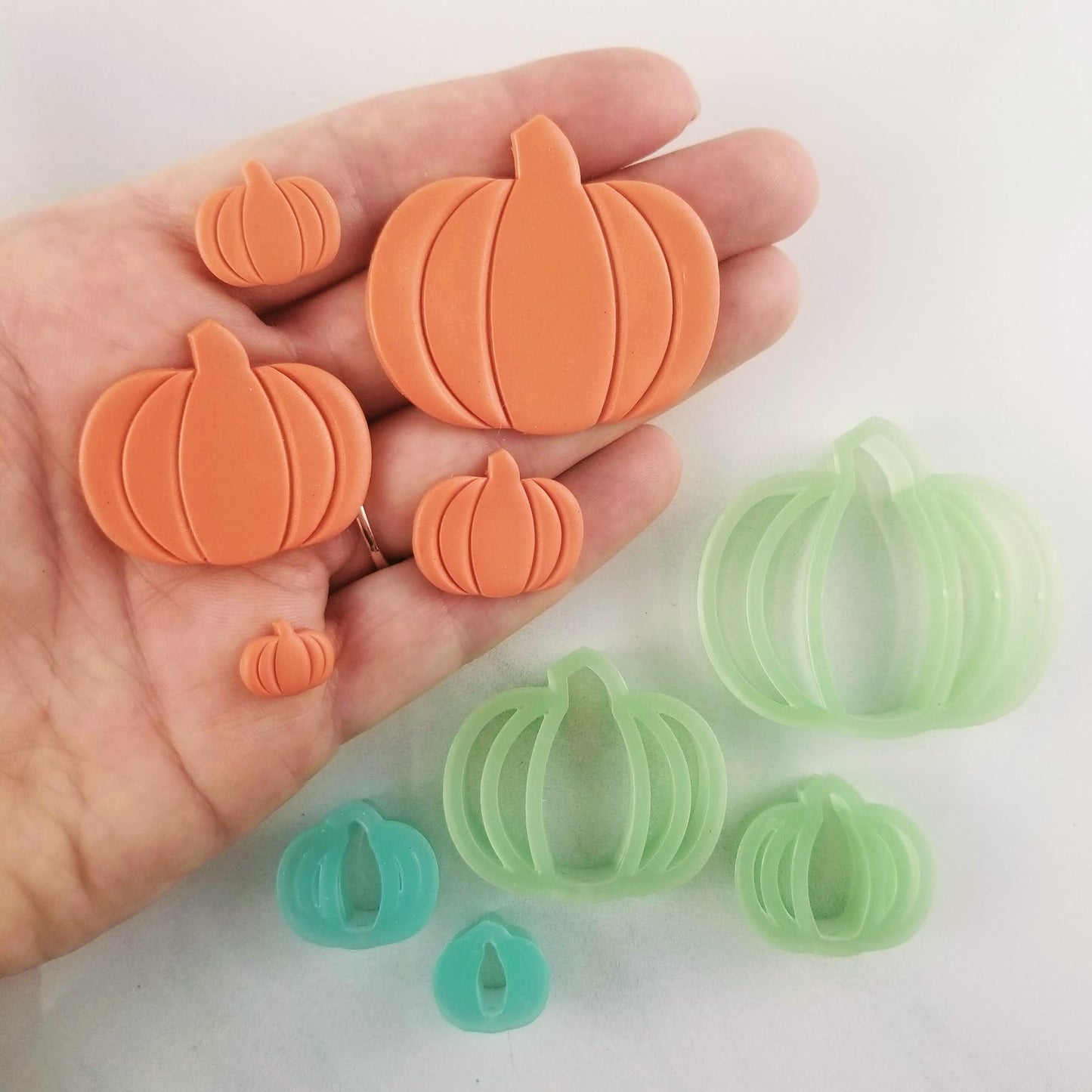 debossed pumpkin shape and design on orange polymer clay