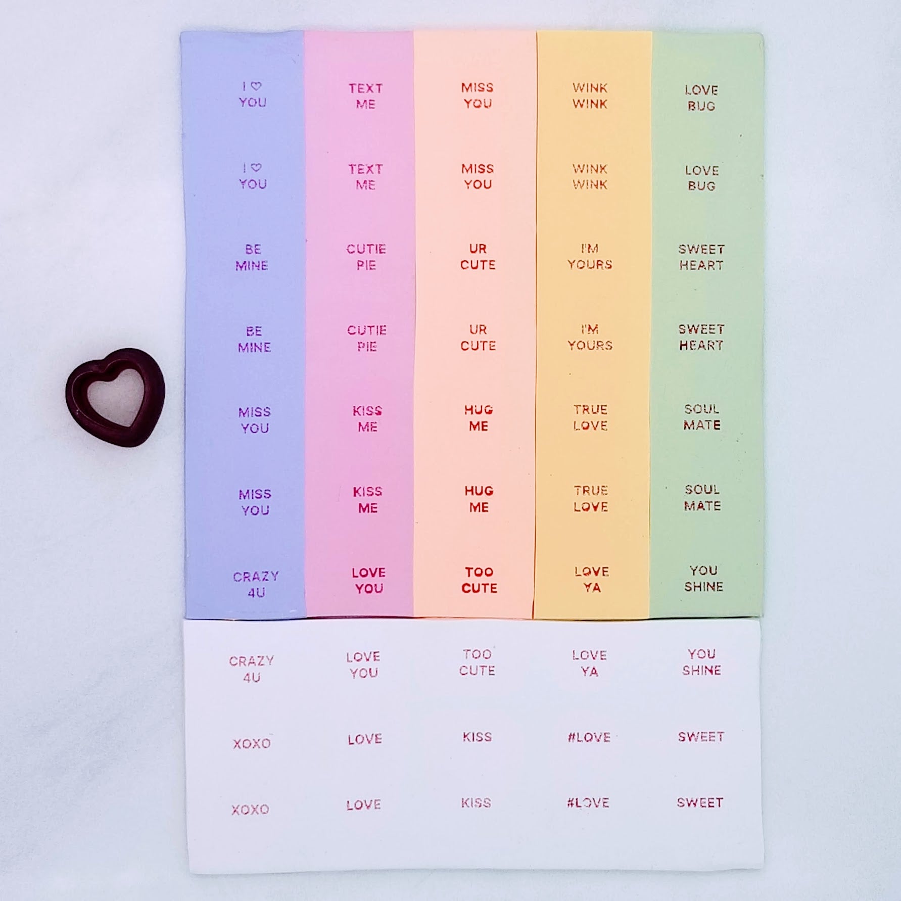 silk screen with 24 different sweet phrases commonly seen on Valentine's day candy on polymer clay